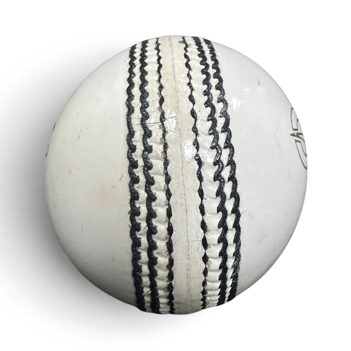 Close-up of the hand-stitched seam on a GO 156g white leather cricket ball